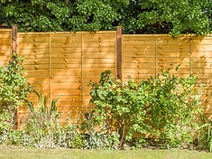 Lap panel fence run installed in a garden