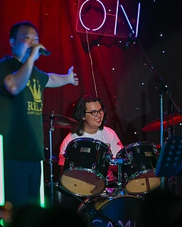 Drummer laughing with bandmates