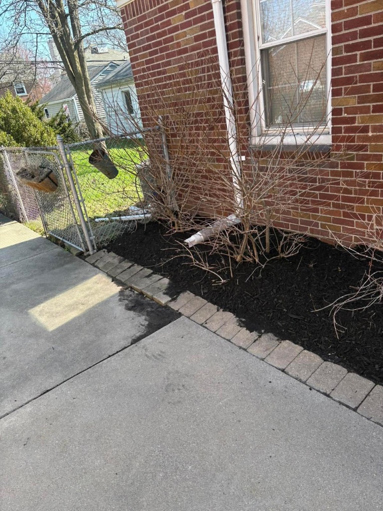 Weed barrier installation before mulching in Grosse Pointe Park