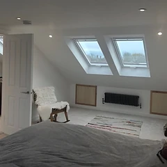 Finished Velux loft conversion bedroom with eaves storage in East Sussex