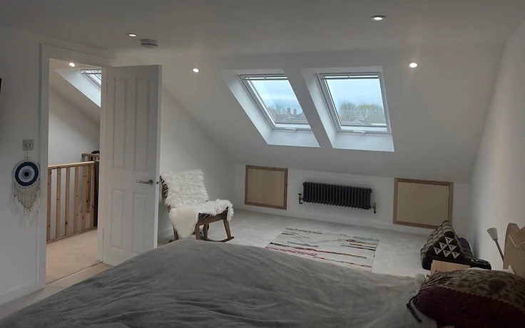 Finished Velux loft conversion bedroom with eaves storage in East Sussex