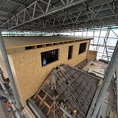 New timber-framed dormer being built under a temporary scaffold roof in Brighton