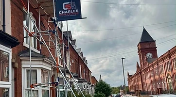 Scaffolding with Charles Scaffolding banner on a Leicester street