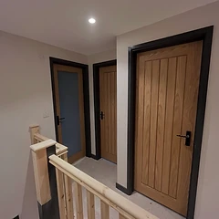 Solid oak internal doors with dark architrave and a new pine staircase
