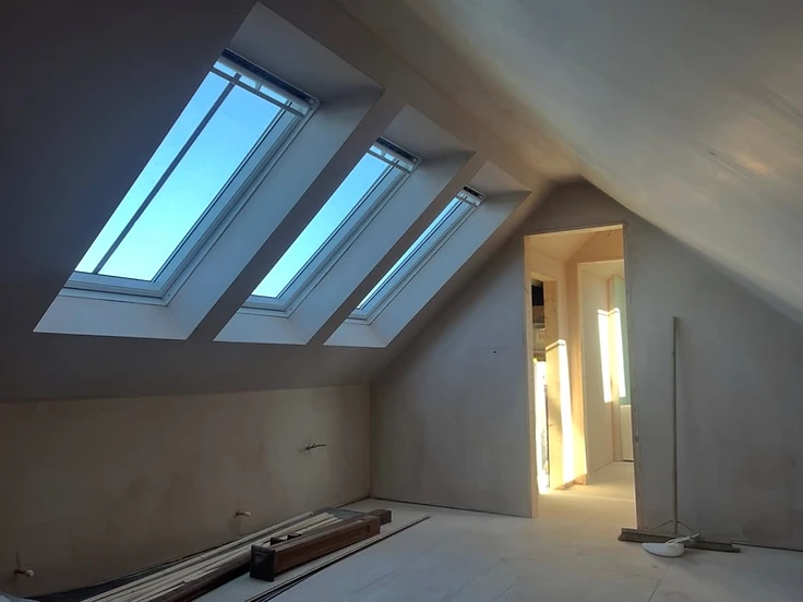 Loft conversion with three Velux windows boarded and ready for plastering