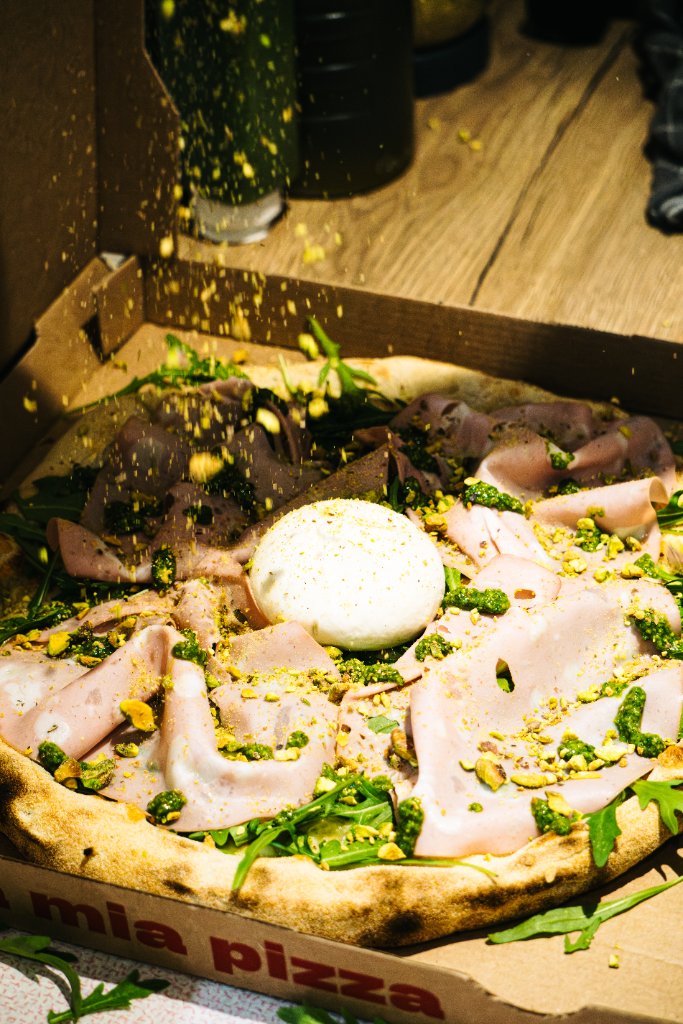 Pizza garnie de burrata, pistaches et charcuterie italienne