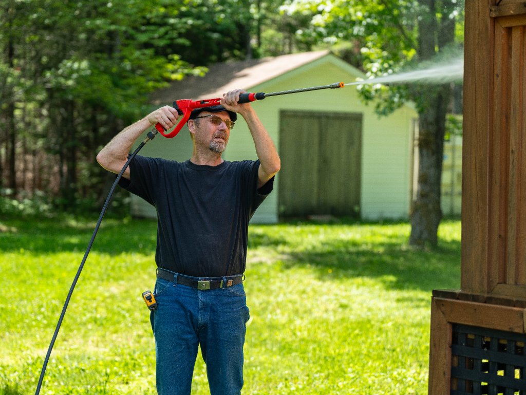 Steve Matthews pressure washing a home exterior