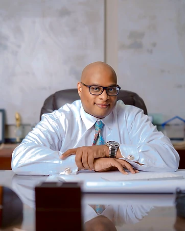 Dr. John Wynn — Approved headshot — portrait at desk