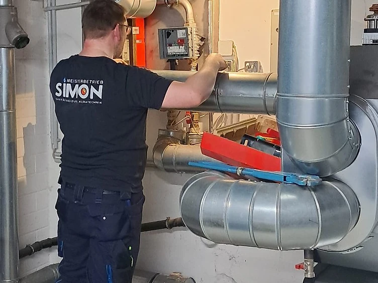 Mitarbeiter von Gebäudetechnik Simon bei der Arbeit an einer Heizungsanlage
