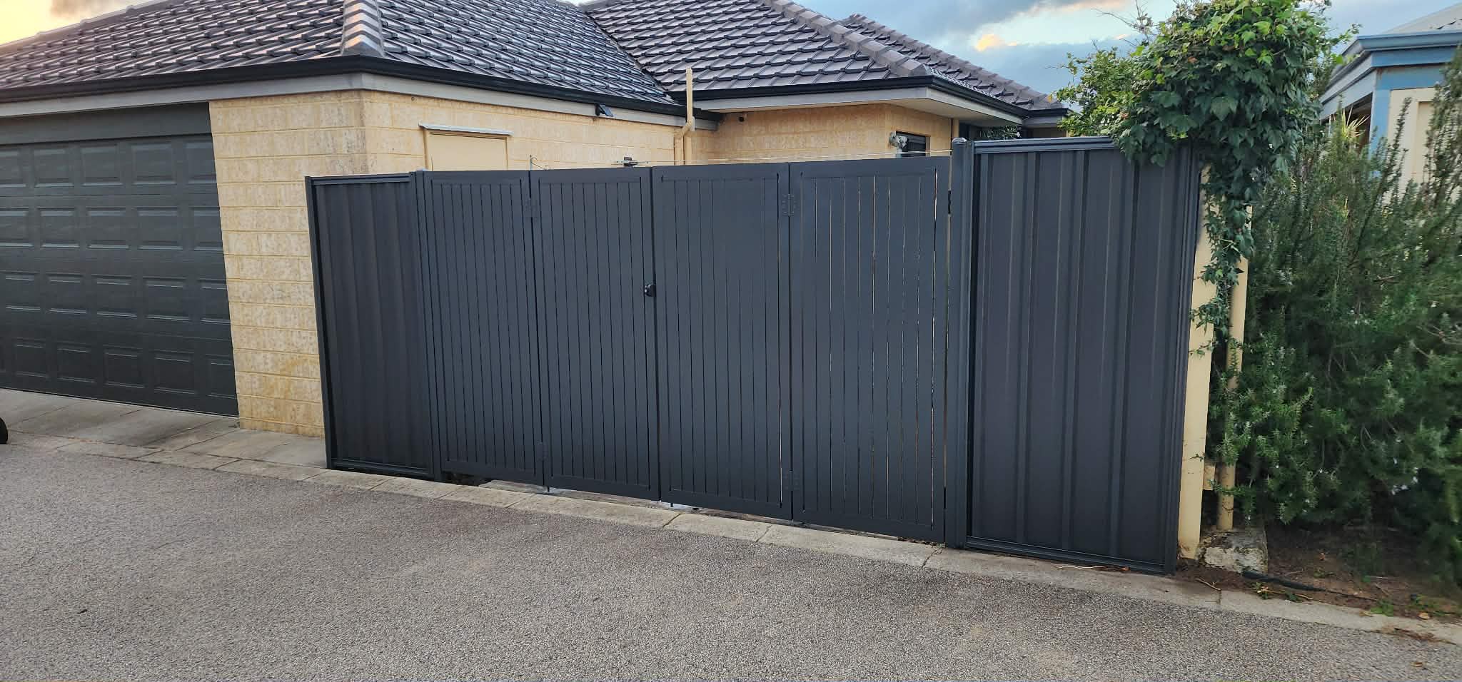 White aluminium privacy gate with matching perimeter fence and garden palm