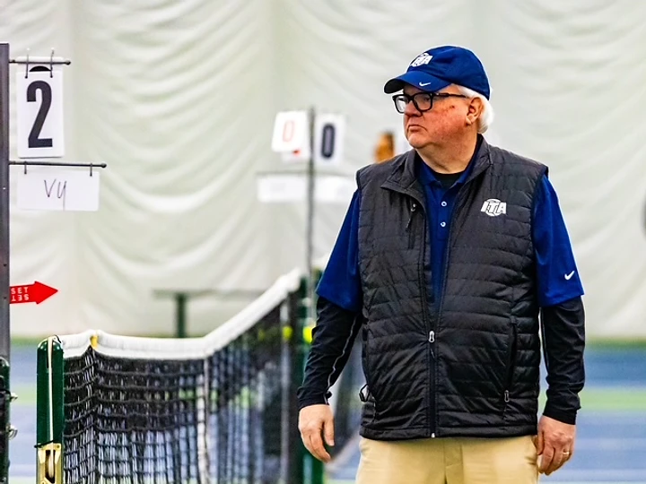 Don officiating an indoor collegiate match
