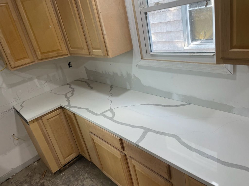 Calacatta quartz L-shaped kitchen countertop installation