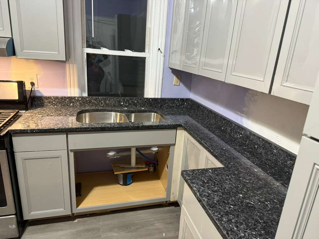 Blue pearl granite countertop with stove and range hood