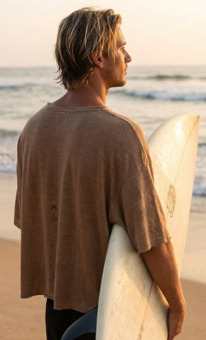 Surfer wearing Libre clothing on the beach at golden hour
