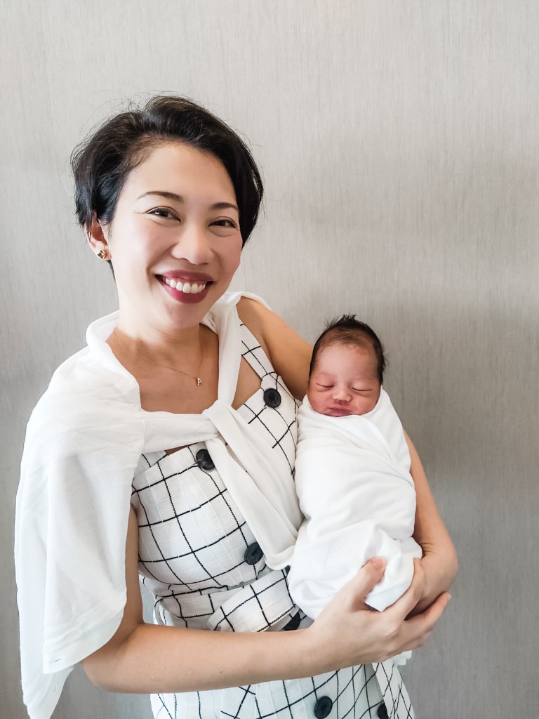 Dr Shilla holding a newborn baby after delivery