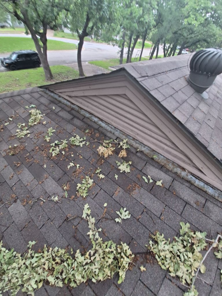 Storm damage and roof debris on a Arlington home after a North Texas hailstorm