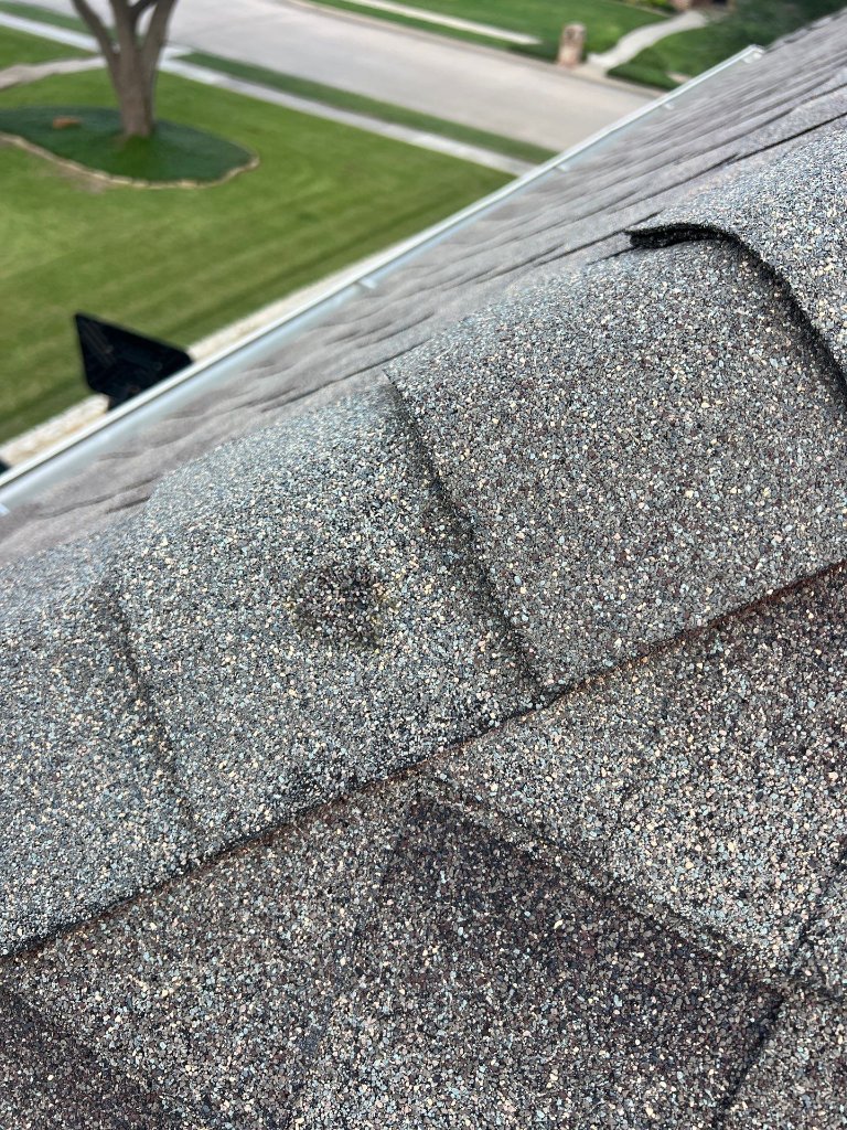 Keller Texas Puncturein Shingle Repairedwith Siliconeand Granuals - Roof Repair project photo by Becker Roofing and Exteriors