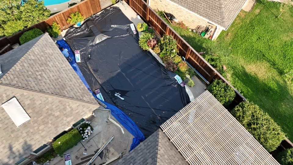 Emergency tarp covering a storm-damaged roof section in the DFW area