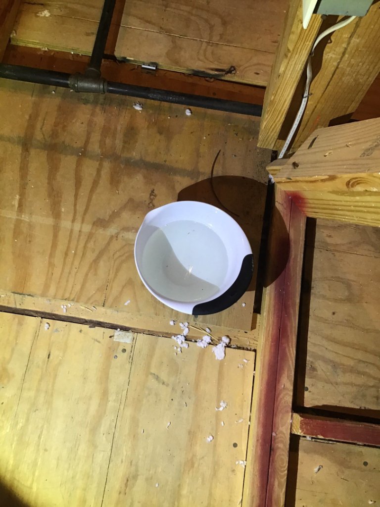Roof leak dripping into a bucket inside a North Texas home before Becker Roofing repair