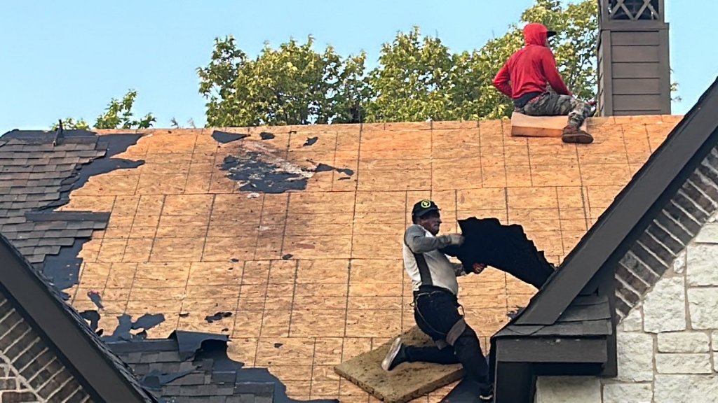 Roof tear-off in progress on a Grapevine, TX home with decking exposed