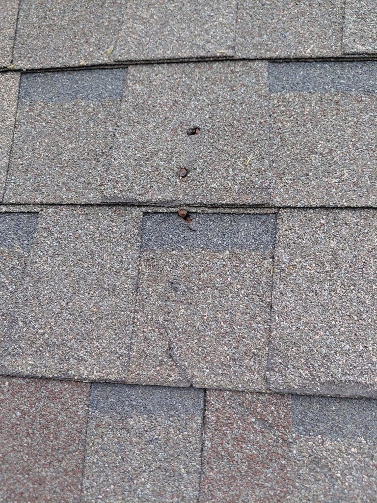 Roof leak found from unsealed nail holes in wind-damaged shingles in Southlake, TX
