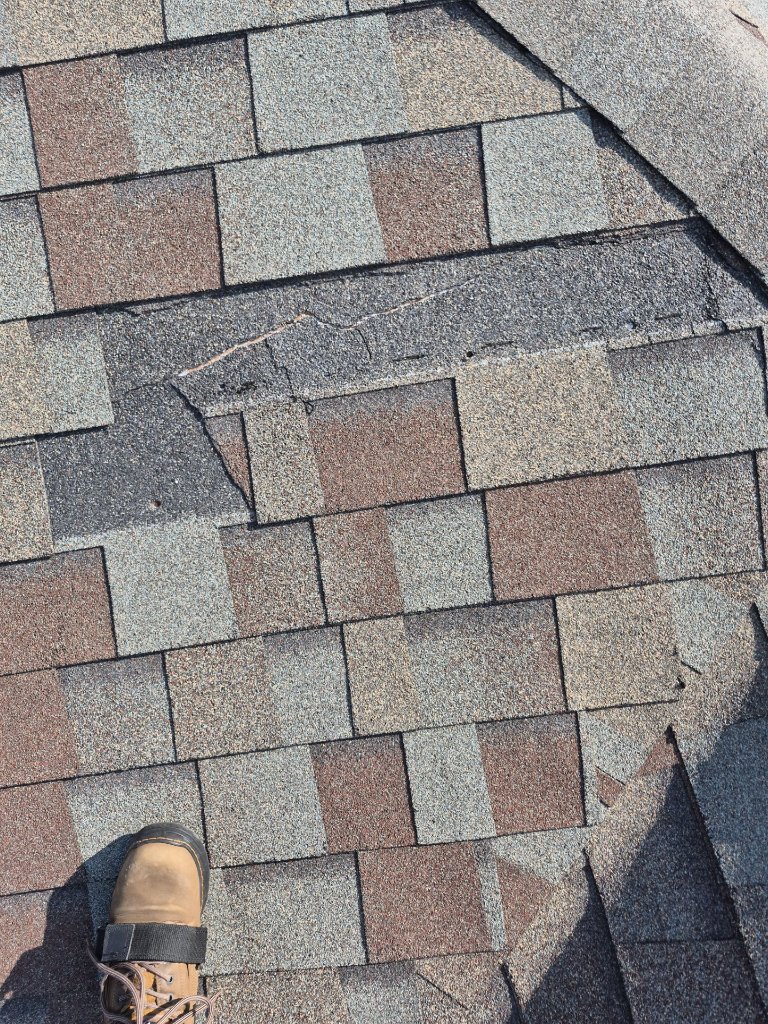 Arlington, TX roof with shingles blown off by high winds, documented by Becker Roofing and Exteriors