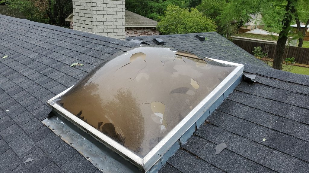 Skylight damaged and busted out by hail on a Southlake, TX home, photographed by Becker Roofing and Exteriors