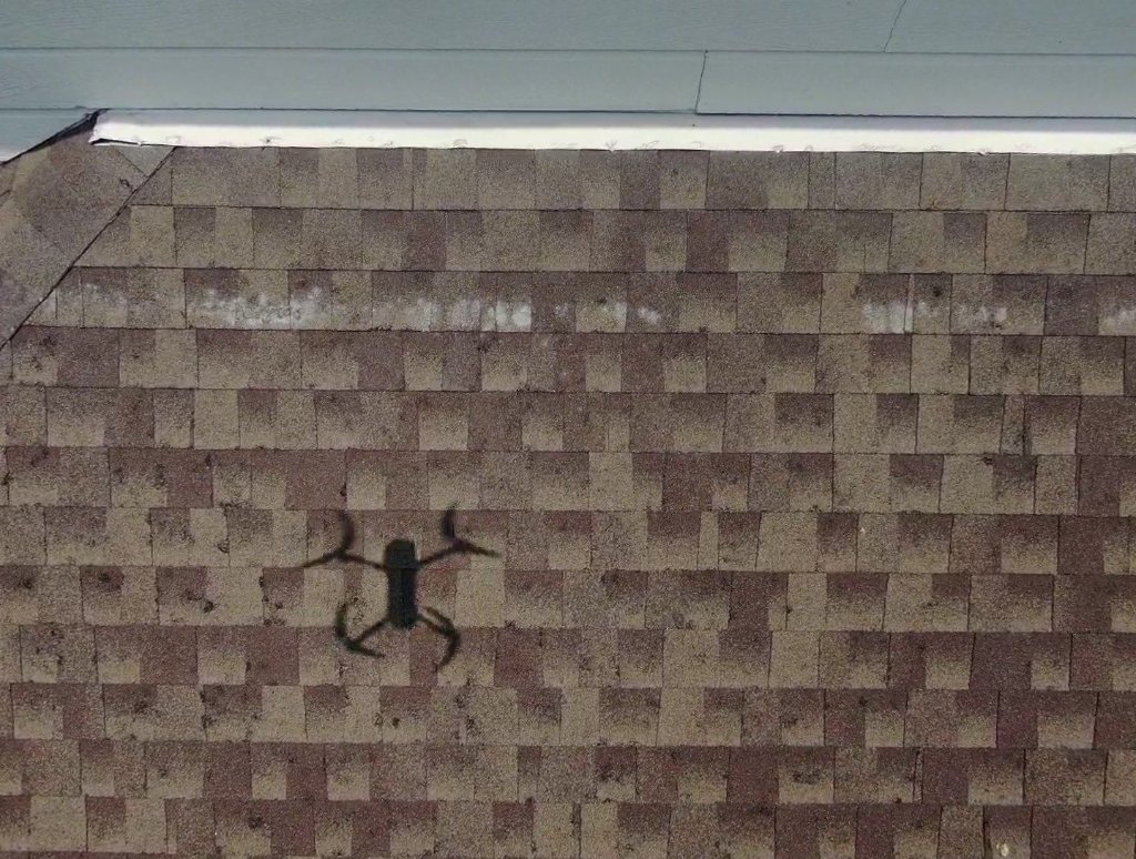 Wind-driven hail damage on an asphalt shingle roof in Collin County