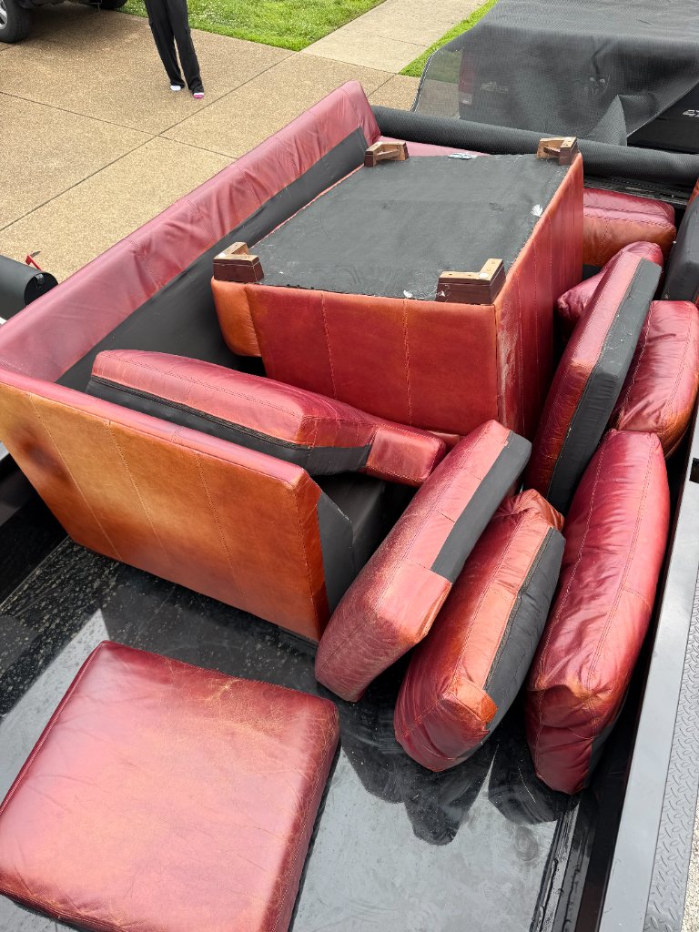 Leather couch pieces loaded into truck bed for hauling