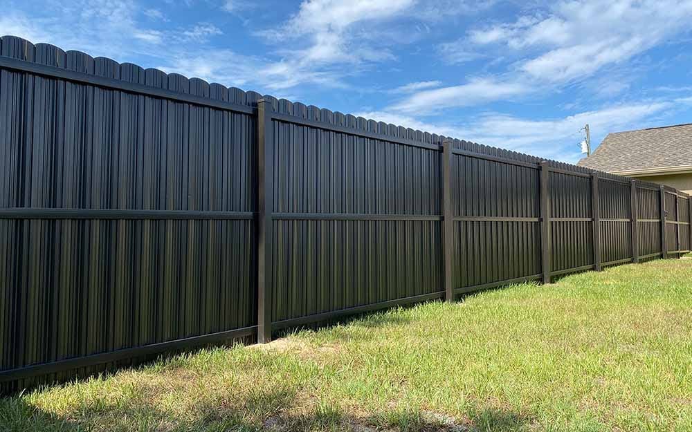 Matte black metal fence installation