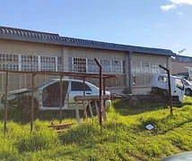 Vehicle body shells and a truck chassis in the workshop yard