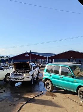 Bakkies and a green Mitsubishi in the OCHIEZ workshop yard
