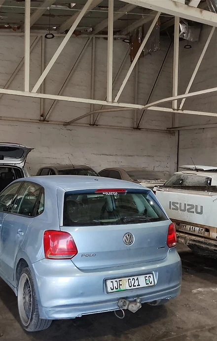 Vehicles inside the OCHIEZ workshop, including a Volkswagen Polo and Isuzu bakkie