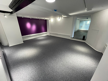 Henry Adams, Midhurst: finished office with purple accent wall and track lighting