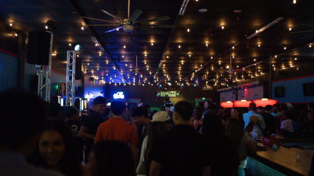A bartender pouring a colorful drink at Shorty’s