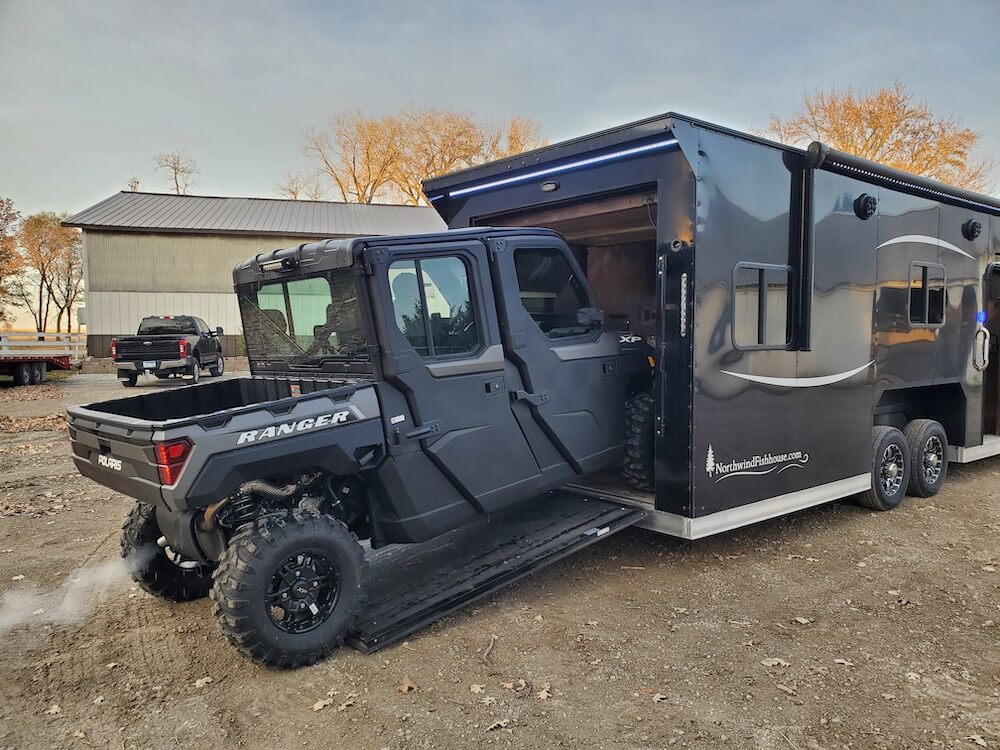 Black toy hauler with Polaris Ranger