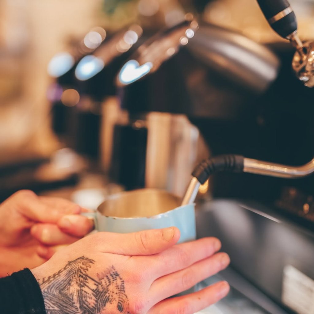 Barista crafting coffee at The Hideout Rosebud
