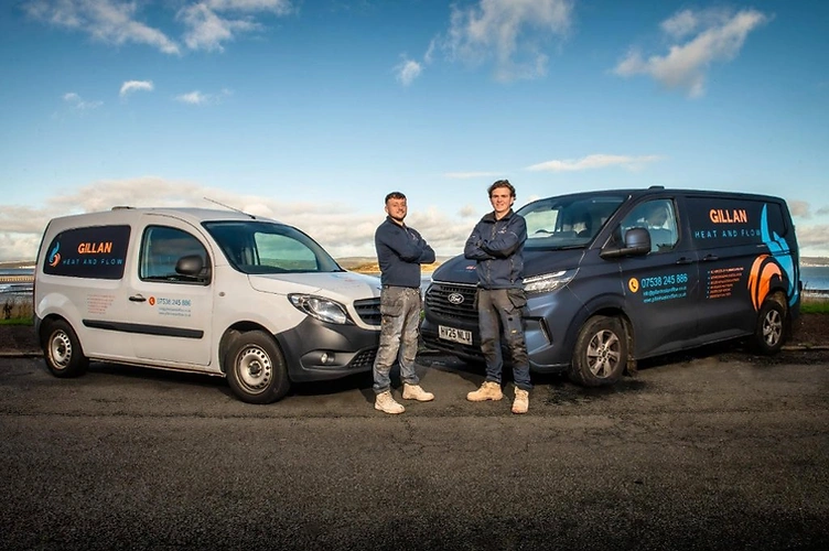 The Gillan Heat and Flow team with their two branded vans on the East Lothian coast