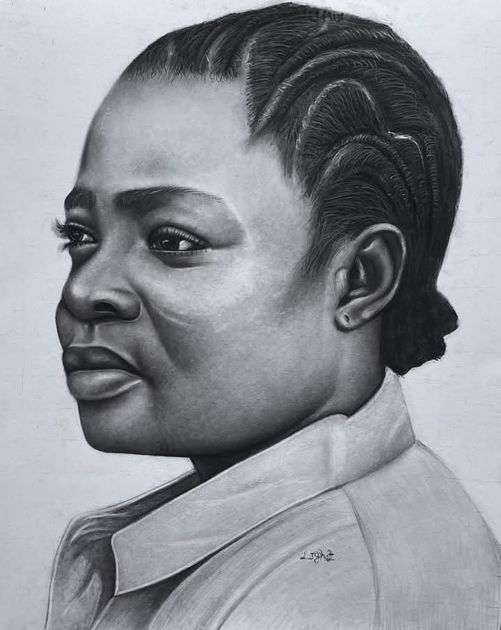 A profile portrait of a woman in contemplation, highlighting the grace of her features and braided hair.