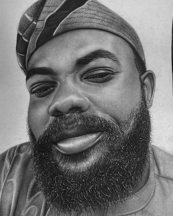 A bearded man in a striped cap, his gentle expression conveying deep thought and inner peace.