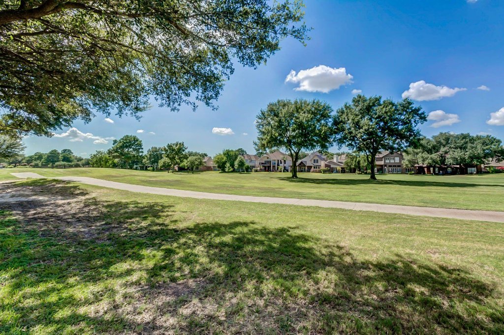 View of the backyard facing an open green space near Hearthstone Houses