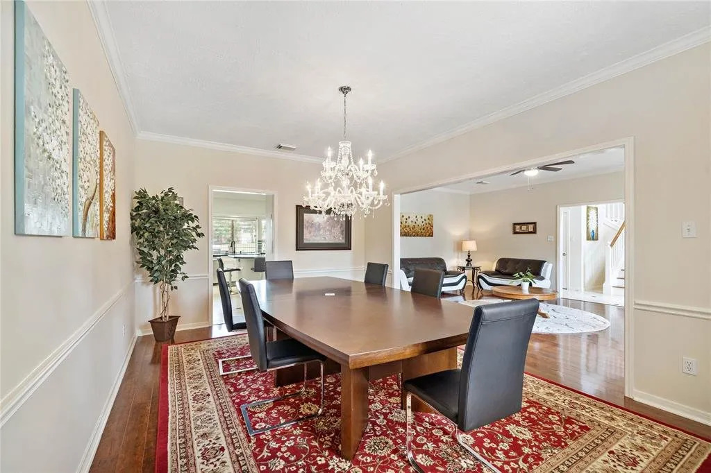 Dining room at Hearthstone Houses with a large wooden table and warm lighting