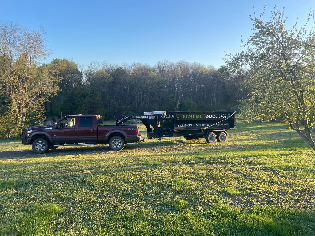 ZK truck and full dumpster in green field