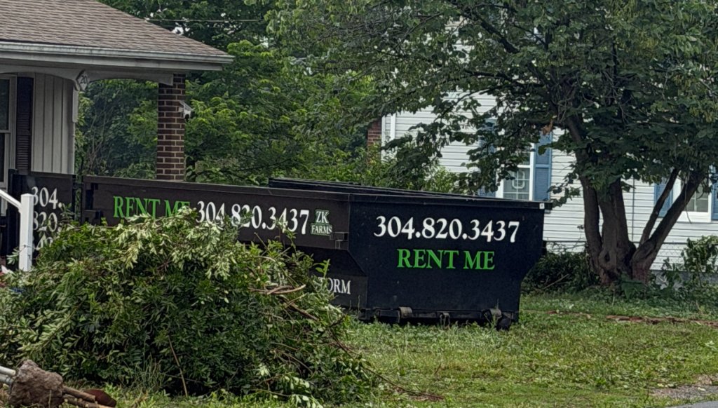 ZK truck and dumpster trailer in field