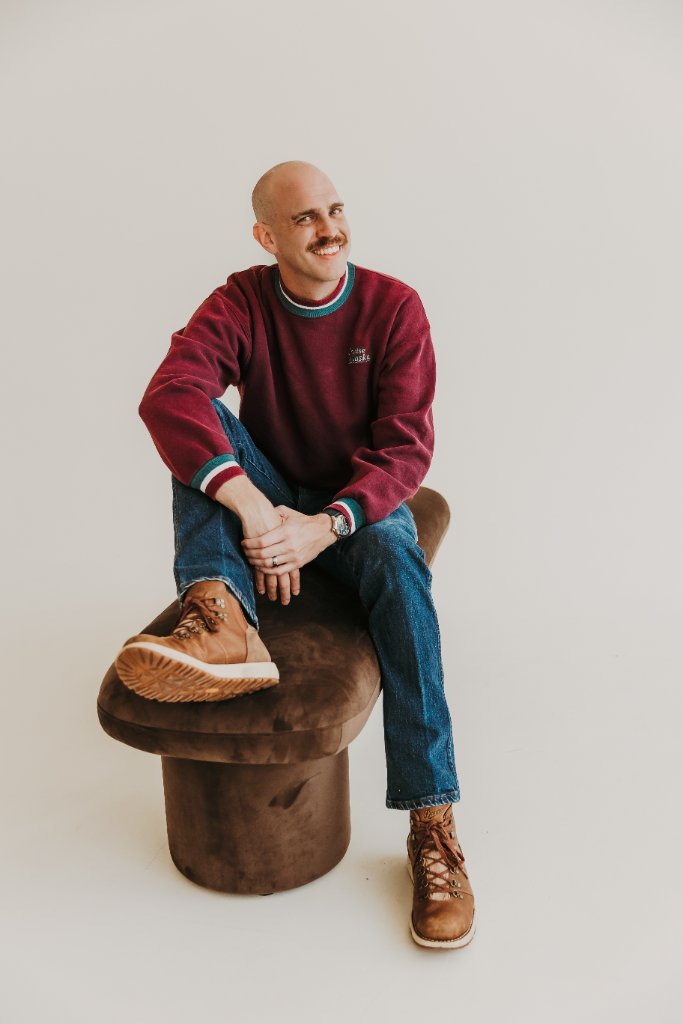 Scott Bedgood portrait — seated in casual burgundy sweater, relaxed and approachable