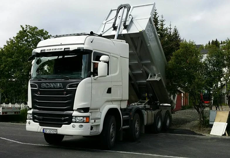 Hvit Scania tippbil med hevet lasteplan