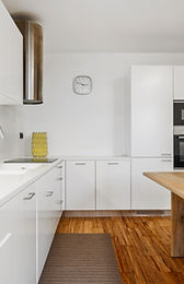 Minimalist white kitchen with oak island