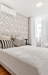 Bedroom with tufted headboard and black nightstands