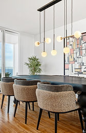 Dining area with statement chandelier and balcony view