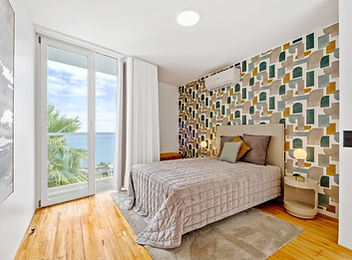 Bedroom with geometric green and mustard wallpaper